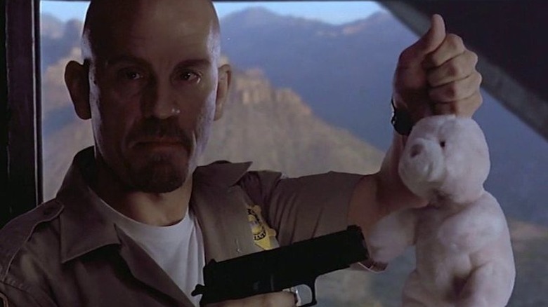 Malkovich holding gun to stuffed bunny