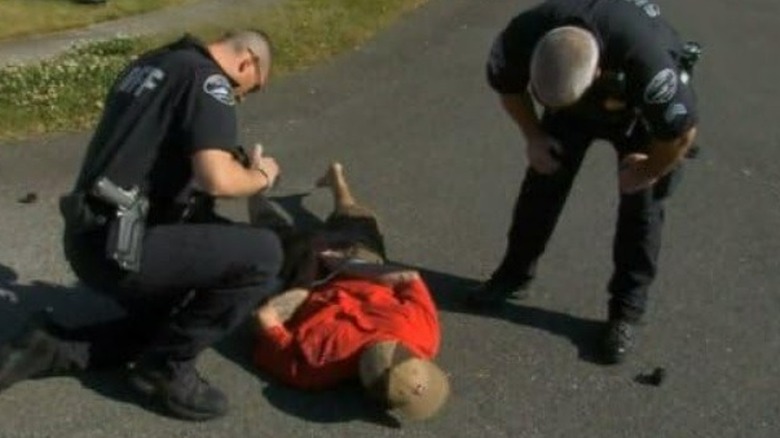 Officers with suspect in street