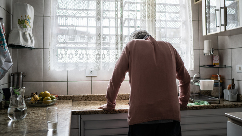 Person standing in kitchen