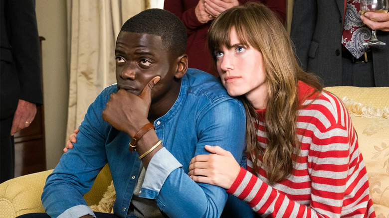 Allison Williams holding Daniel Kaluuya