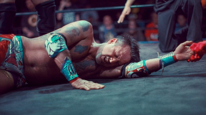 David Arquette on mat in wrestling match