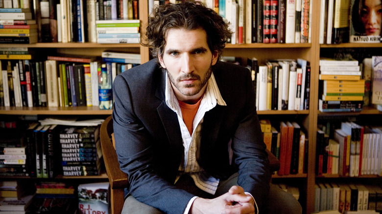 David Benioff sits in front of bookshelves