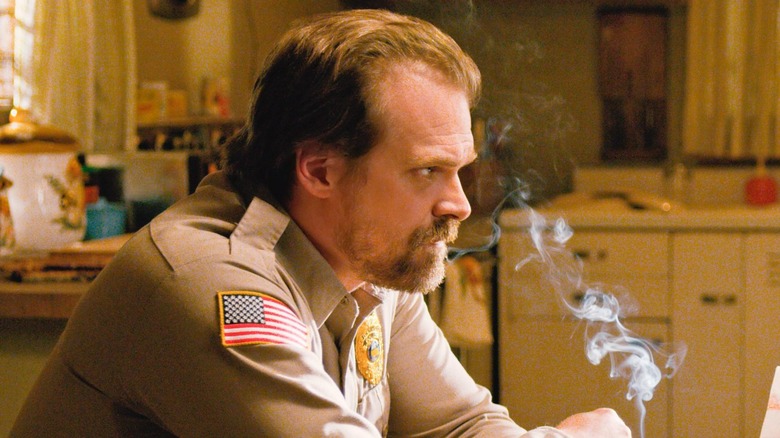 David Harbour smoking in uniform