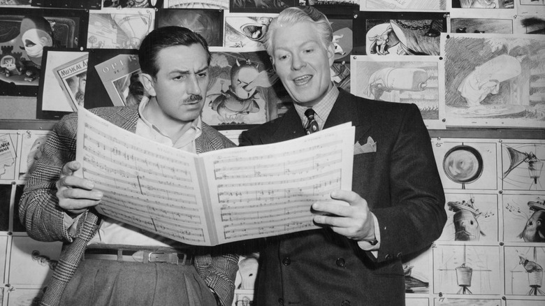 Walt Disney holding sheet music