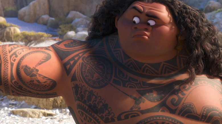 Maui looks at his moving tattoo