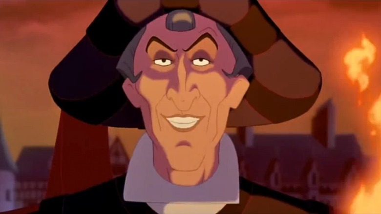 Frollo grinning menacingly with fire