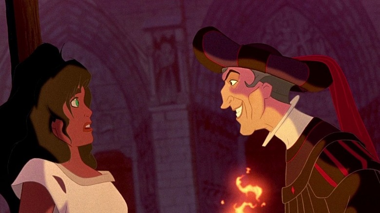 Frollo threatening Esmeralda with fire