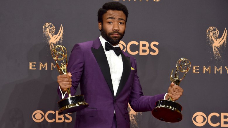 Donald Glover holds two emmys