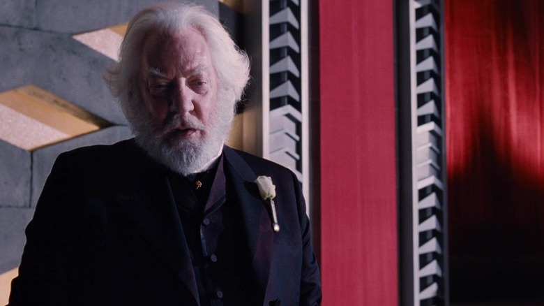 President Snow with a white rose on his lapel