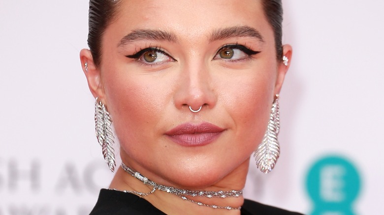 Florence Pugh staring wearing silver jewelry