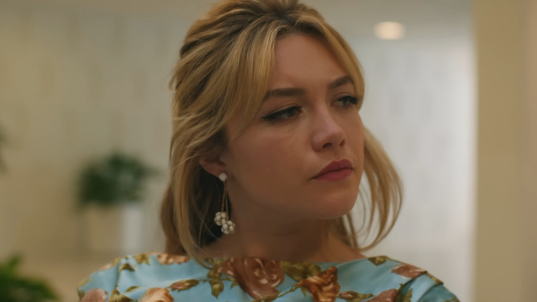 Florence Pugh in a blue dress staring