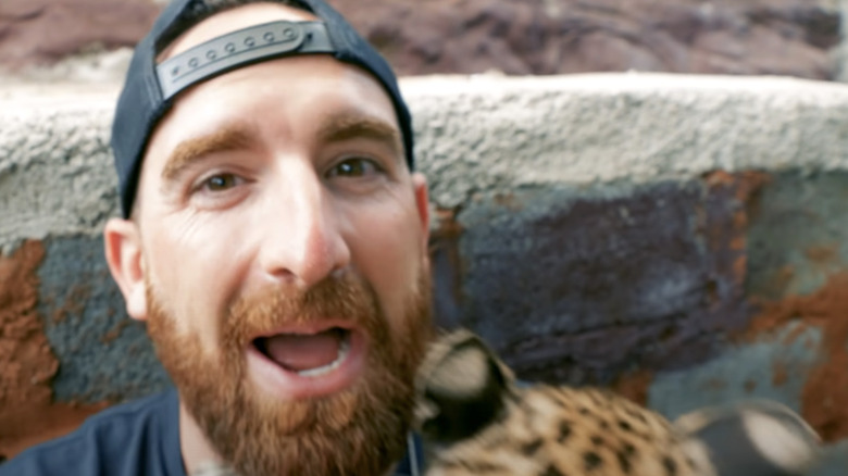 Toney cuddling a young leopard