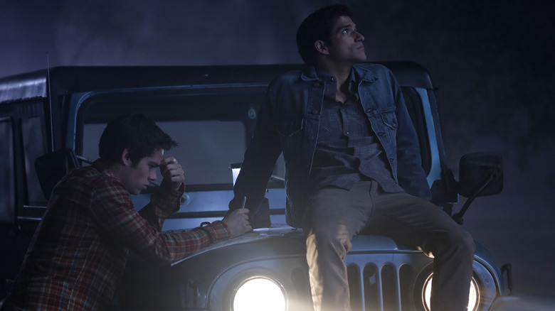 Stiles repairing the Jeep with Scott