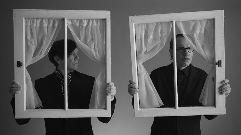 Ron and Russell Mael looking through windows