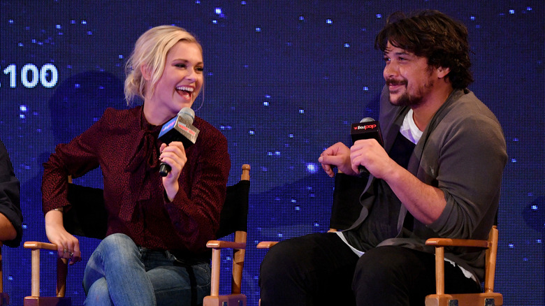 Eliza Taylor and Bob Morley laughing on stage