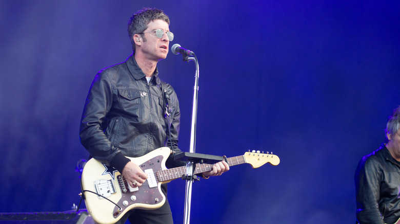 Noel Gallagher playing guitar