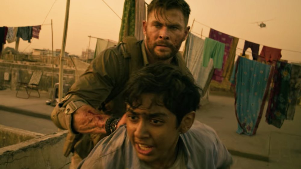 Chris Hemsworth as Tyler Rake and Rudhraksh Jaiswal as Ovi Mahajan Jr. in Netflix's Extraction