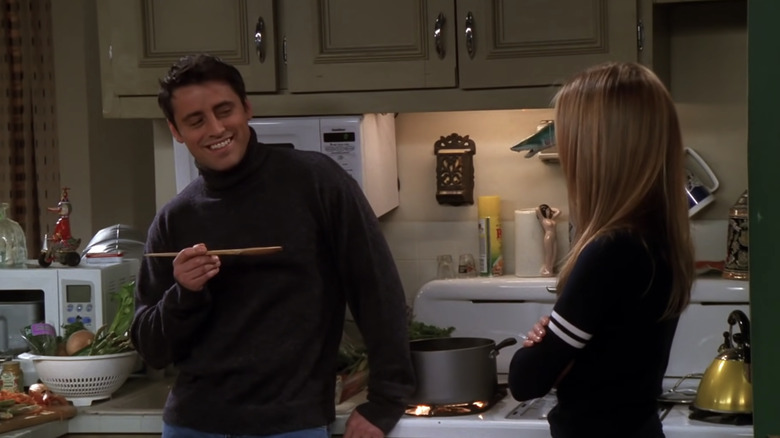 Joey in kitchen holding ladle