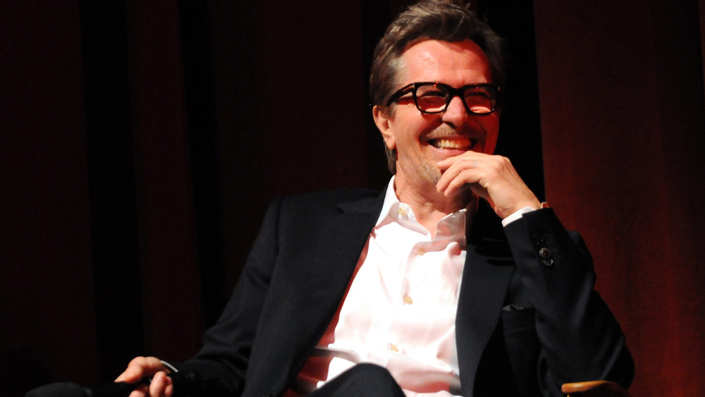 Gary Oldman smiling while seated