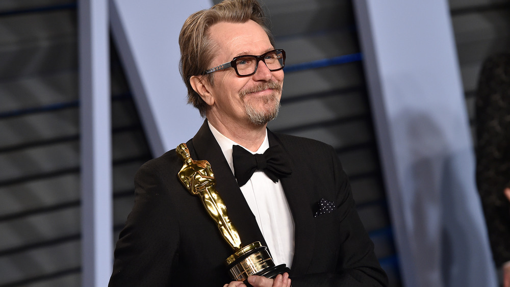 Gary Oldman holding an Oscar