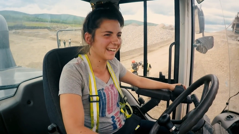 Tatiana Costa smiling and operating heavy machinery