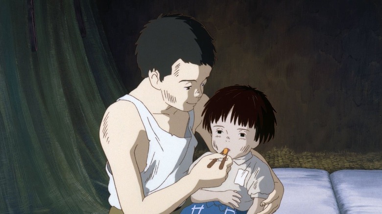 Seita feeding Setsuka with chopsticks