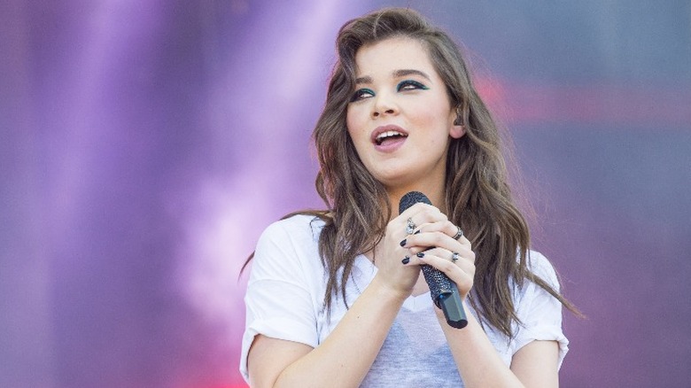 Hailee Steinfeld holding microphone on stage