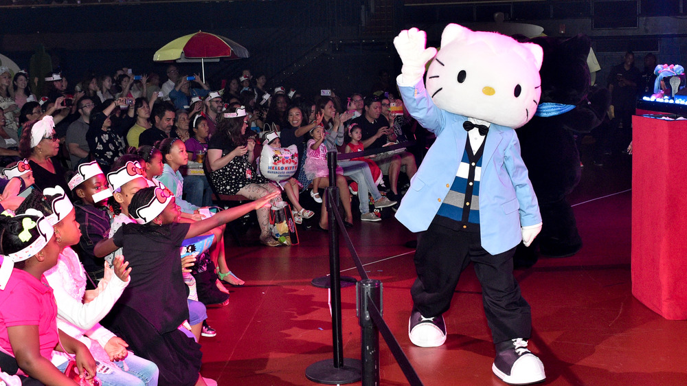 Dear Daniel walks in front of a crowd of Hello Kitty fans