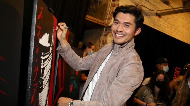 Henry Golding signing autograph at Comic Con