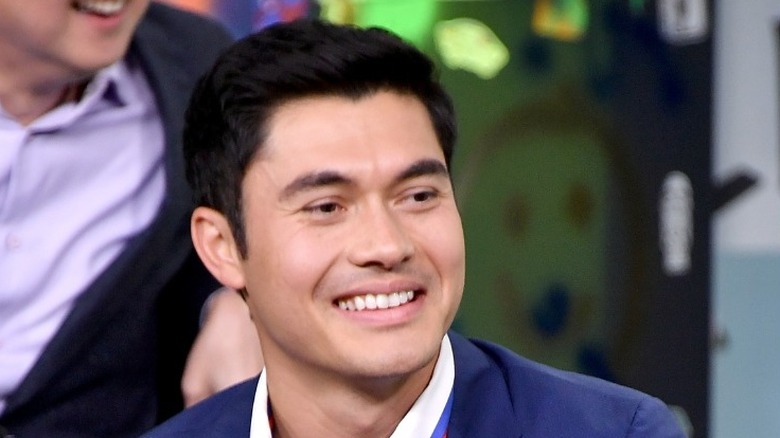 Henry Golding smiling doing interview 