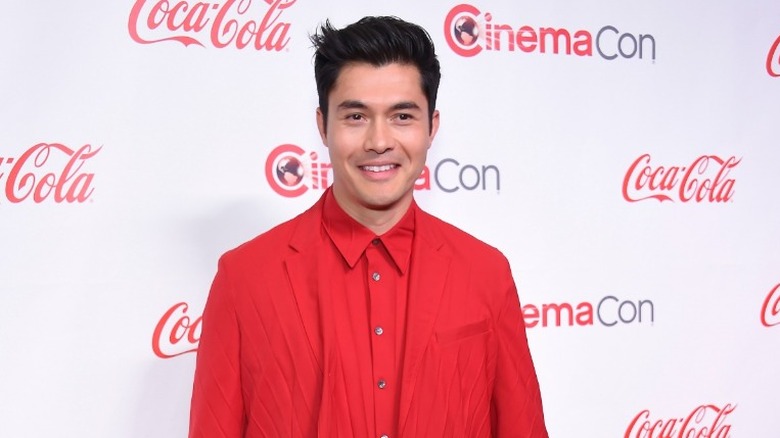 Henry Golding in all red suit