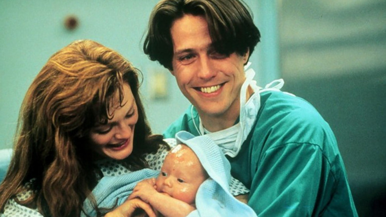 Hugh Grant and Julianne Moore hold a baby