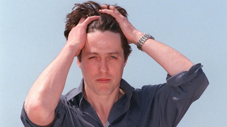 Hugh Grant ruffling his hair