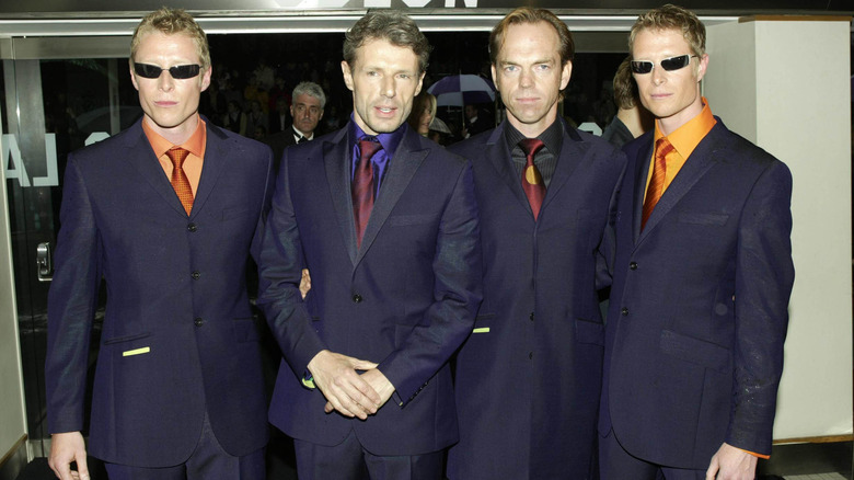 Hugo Weaving with the Matrix cast, posing in suits