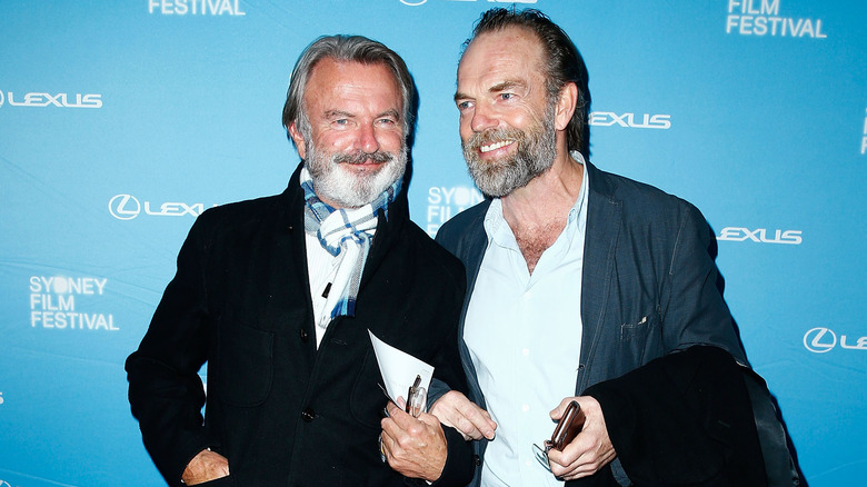 Sam Neill and Hugo Weaving both smiling