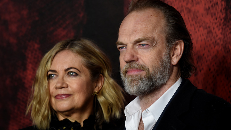 Hugo Weaving with his partner, both posing