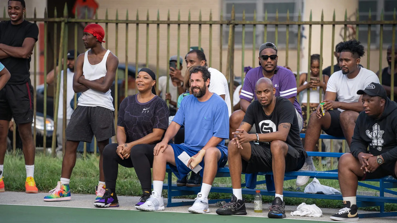 Group of people sitting outside watching basketball