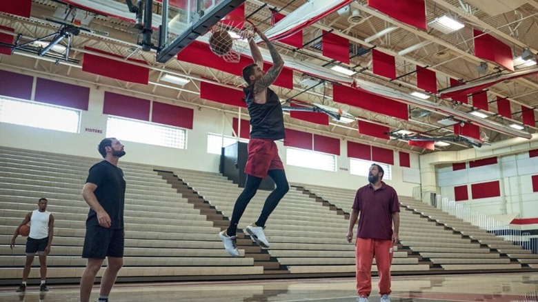 Group of men playing basketball in a gym