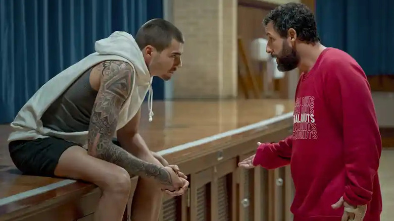 two men talking in a gym