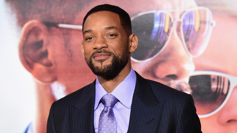 Will Smith smiles on red carpet