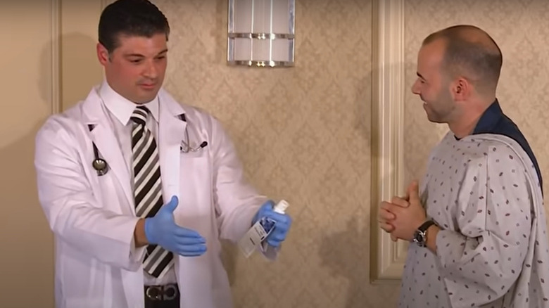 Murr in a hospital gown with a doctor