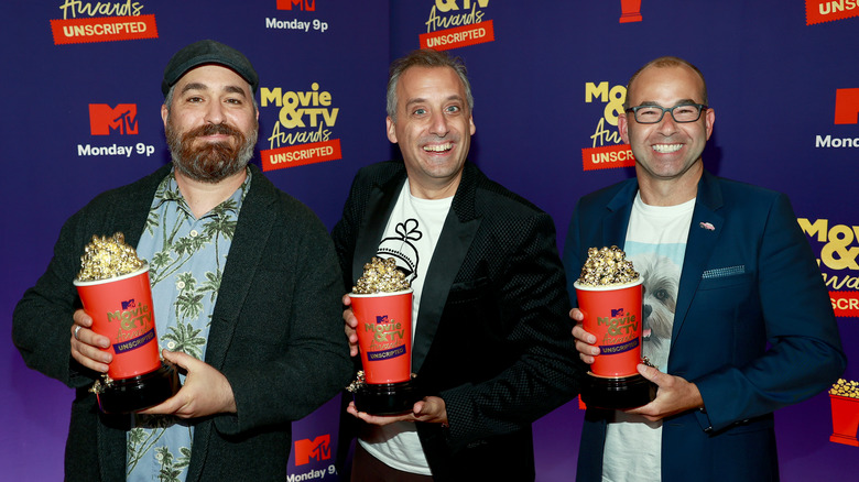 Impractical Jokers' cast holding golden popcorn awards