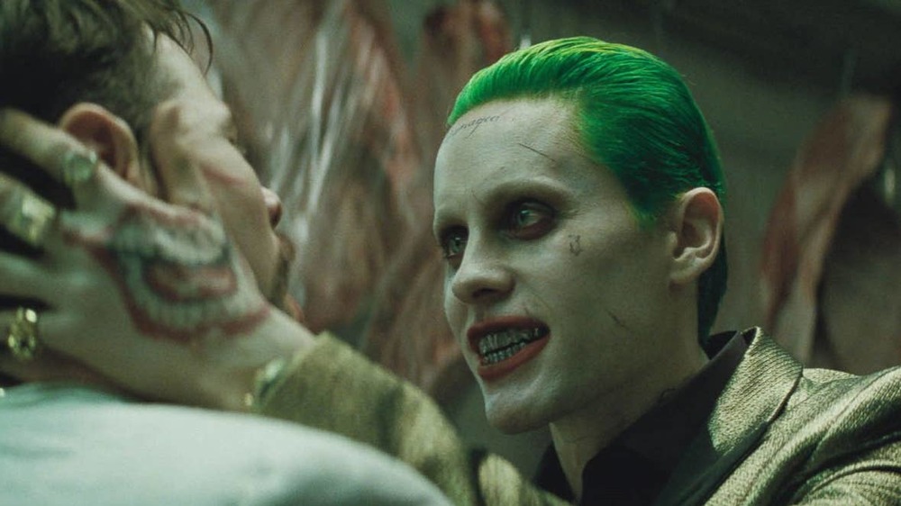 Joker grasps a man's head