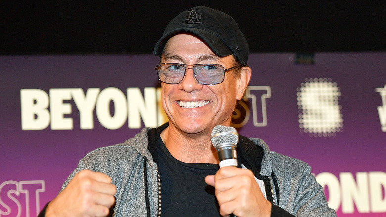 Jean-Claude Van Damme smiling with microphone