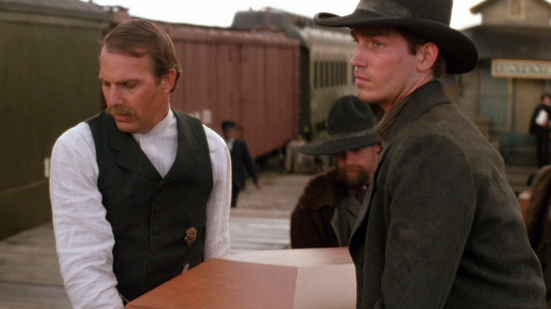 Wyatt and Warren Earp carrying casket