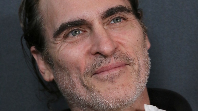 Joaquin Phoenix smiles and stares