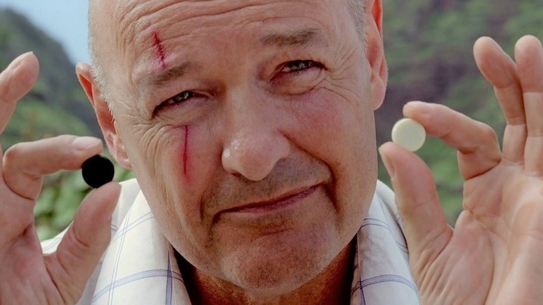 John Locke holding game pieces