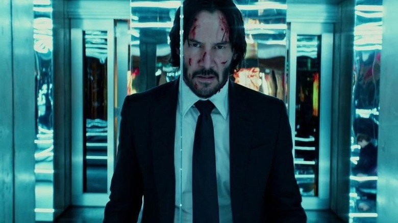 John Wick standing in mirrored hallway