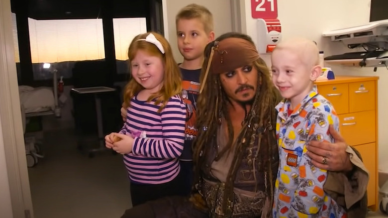 Johnny Depp as Jack Sparrow poses with kids