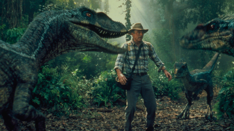 Sam Neill cornered by velociraptors